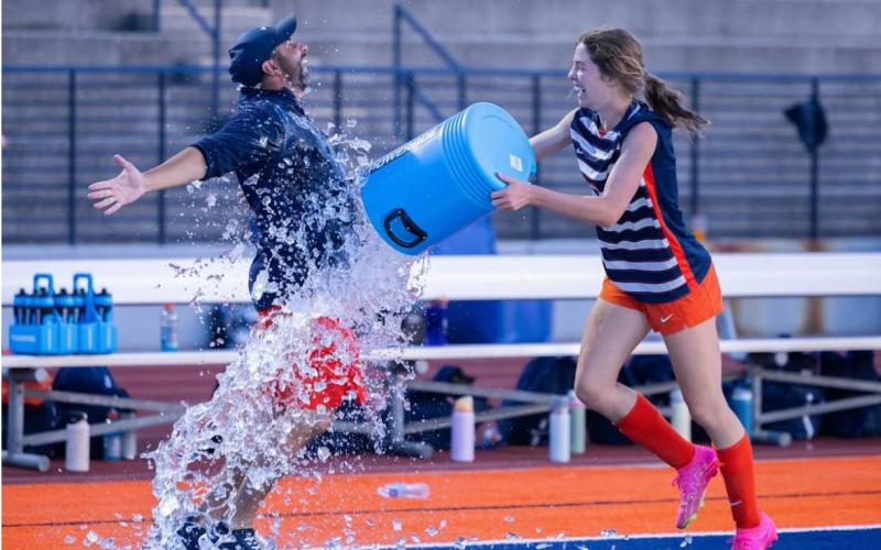 After trying to evade a water dousing from Abigail Hotard, Head Coach Jeff LaBarbera finally accepted his fate following his team’s statement win Tuesday. DIANA VEGA/HCHS
