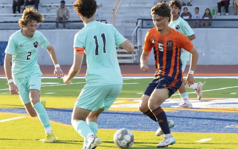 Payton Adams carves up a trio of Panther defenders during the HCHS boys’ win earlier this week. HABERSHAM SOCCER