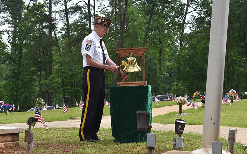 Bill McAllister tolls the bell in memory of those who died in wars at the ceremony at the Veterans of Foreign Wars Memorial Park. Samantha Sinclair/Staff