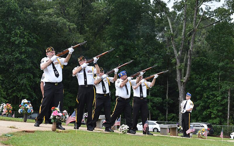 Honor Guard members Roy Albea Jr., Rob Wallace, Bob Trousdale, VFW Auxillary President Steven Hawkins and Dr. Ed Hendricks fire the volleys during the morning ceremony as Danny Stephens waits to play Taps. Samantha Sinclair/Staff
