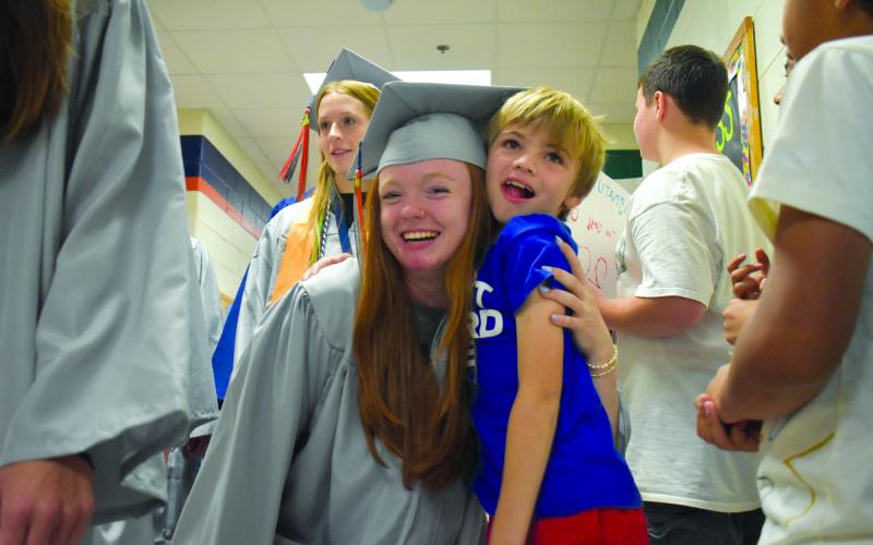 During the Elementary School Walk at Level Grove Elementary on Thursday,  Katelynn Lobuono gets a hug from third grader Lincoln Chitwood, one of the kids she knows from working at the Boys and Girls Club. SAMANTHA SINCLAIR/Staff