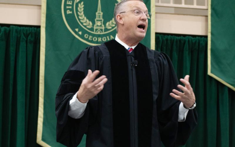 U.S. Secretary of Veteran Affairs Doug Collins addresses the Piedmont’s Class of 2025 with a simple message: be curious, because life may take you down a road that’s unexpected. HANNAH CAUDELL/Staff