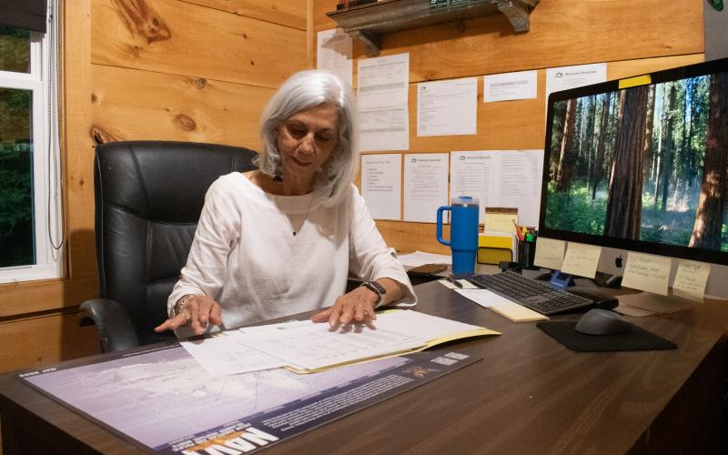 Myra Chandler, a former counselor at Mountain Education, sits in one of the offices at the Habersham campus, looking over past scholarships that local donors have given to the school over the past few years. HANNAH CAUDELL/Staff