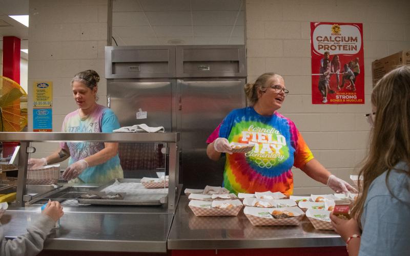 Ann Lewallen (right) works in the Cornelia Elementary School kitchen service line to serve the children coming through for breakfast on Thursday morning. HANNAH CAUDELL/Staff