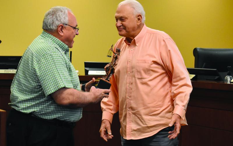 Commission Chairman Jimmy Tench, right,  hands Donnie Hunt a statue from the Habersham County Board of Commissioners as a token of their appreciation for his years of service to the county.  Samantha Sinclair/Staff