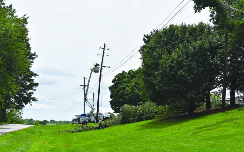 Habersham EMC crews work to repair power lines on Old Cleveland Road on Sunday afternoon. Samantha Sinclair/Staff