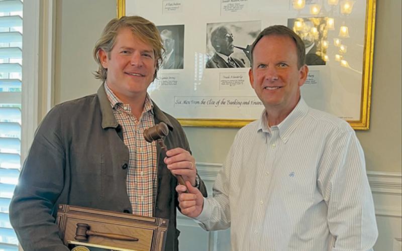 Eric NeSmith hands the gavel to Keith Barlow durring the Georgia Press Association annual meeting Saturday morning. (Submitted)
