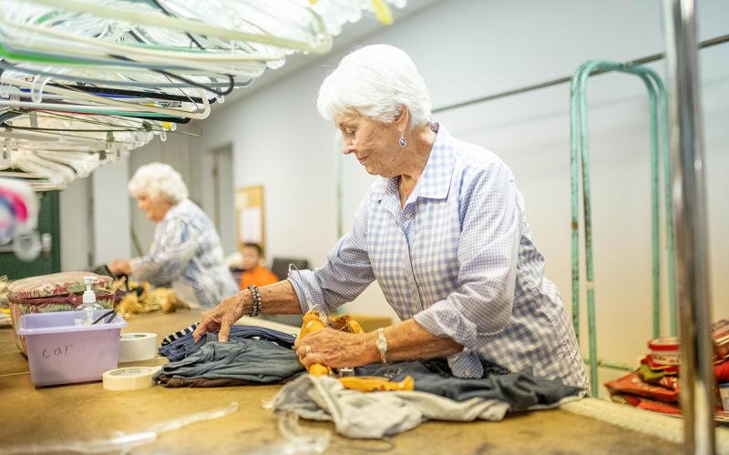 Volunteer Edith Simmons works to tag and fold clothing in the donations section. Sharing and Caring Place accepts donations during open hours. (ZACH TAYLOR/Staff)