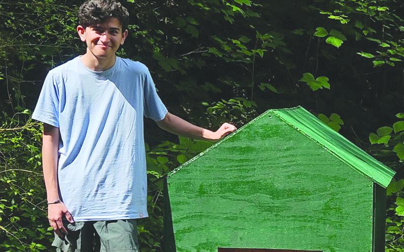 David Quintal poses with one the dog houses he built with a team of volunteers for his Eagle service project. SUBMITTED