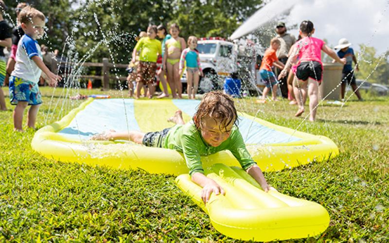 Alex McSherry smiles as he goes just off the edge of the slip-n-slide at the Summer Splashdown event at Tallulah Gorge State Park on Saturday. (Zach Taylor/Staff)