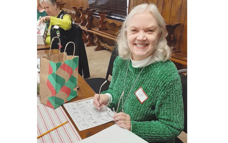 Leslie Rohrabacher enjoys serving in the Tomochichi Chapter of the Daughters of the American Revolution. Above, she works with the chapter to stuff gift bags for veterans last December. (Submitted)