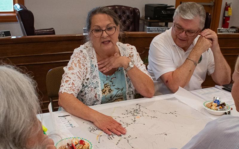 Mayor Gail Armour shows the council a map of the town’s water lines and where the town can possibly expand with the approval of SPLOST VIII funding. (Hannah Caudell/Staff)