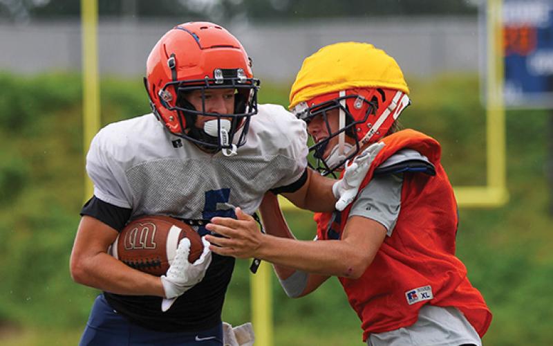 Habersham Central Maverick Chitwood and defender Preston Tatum collide during football practice at Raider Stadium on Wednesday, July 30. (Landen Todd/Staff)