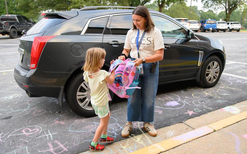 Clarkesville Elementary School Counselor Anna Neese helps kids out of their parents’ cars on the first day of school. (Zach Taylor/Staff)