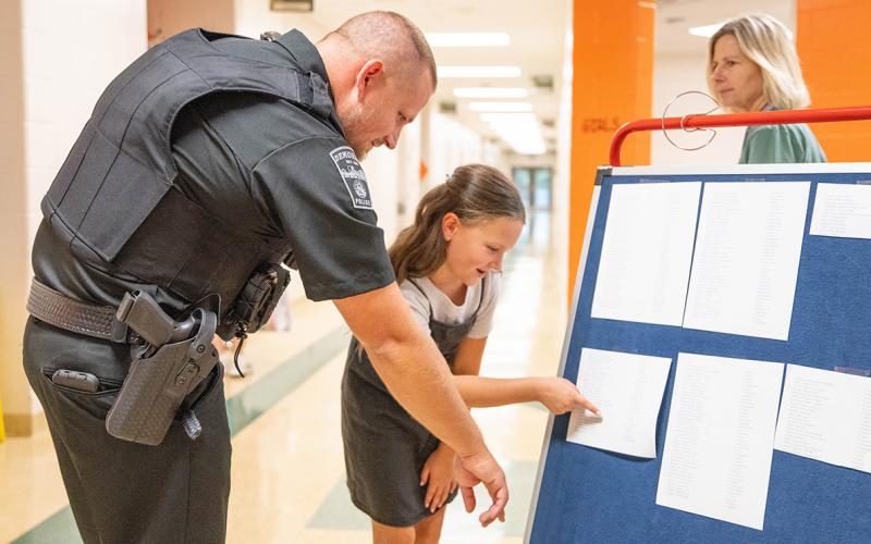 Demorest Elementary’s newest school resource officer (SRO), Joe Chastain, looks at classes with Rosemary Couch at the school’s open house on Wednesday. Chastain begins his first day of SRO duties today under the direction of Demorest Assistant Chief of Police James Minutello. (Zach Taylor/Staff)