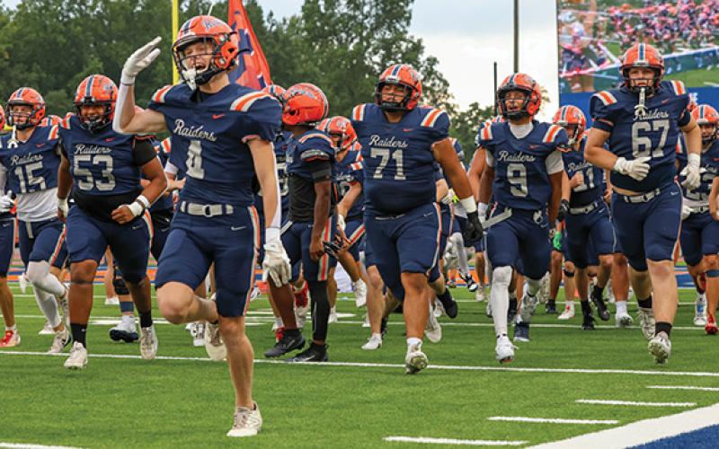 The Raiders run onto the field during the game between Flowery Branch and Habersham Central at Raider Stadium on Friday, Aug. 22.  (Landen Todd)