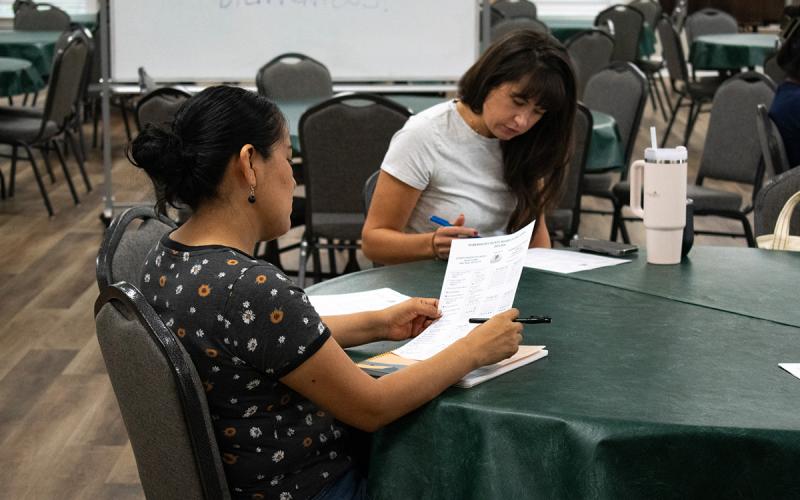Volunteer April Matson (right) prepares to help a returning student for the Volunteers for Literacy Adult English Language Acquisition program. (Hannah Caudell/Staff)