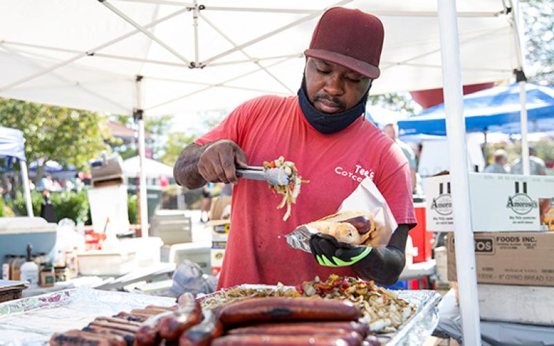 T Perry whips up some meals for hungry customers during last year’s festival. (File)