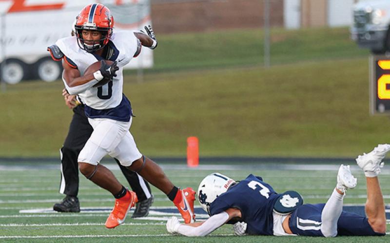 Habersham Central senior running back Donnie Warren (0) runs past a defender during a football game between Habersham Central and White County at Warrior Stadium on Friday, Aug. 29. The Raiders won 17-3. (Landen Todd/Staff)