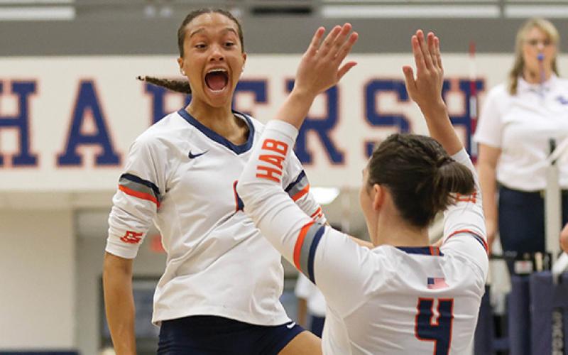 Habersham Central senior Kenzie King (6) celebrates with senior Rainlan Hobson (4) and junior Miley Ragan (1) during a match between Jackson County and Habersham Central at Raider Gymnasium on Tuesday, Sept. 16. (Landen Todd/Staff)