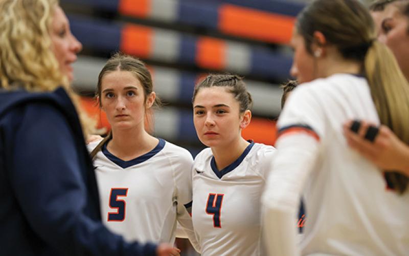 The Lady Raiders huddle up during a match between Jackson County and Habersham Central at Raider Gymnasium on Tuesday, Sept. 16. (Landen Todd/Staff)
