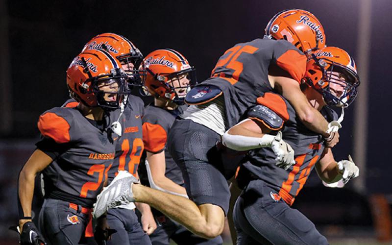 Habersham Central senior linebacker Sawyer Burgess (14) celebrates with his teammates after his interception during a game between Winder-Barrow and Habersham Central at Raider Stadium on Friday, Sept. 26. (Landen Todd/Staff)