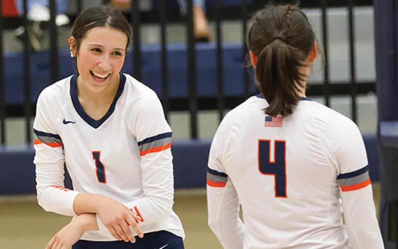 Habersham Central junior Miley Ragan (1) smiles at  senior Rainlan Hobson (4) during a volleyball match between White County and Habersham Central at Raider Gymnasium on Thursday, Sept. 4. (Landen Todd/Staff)