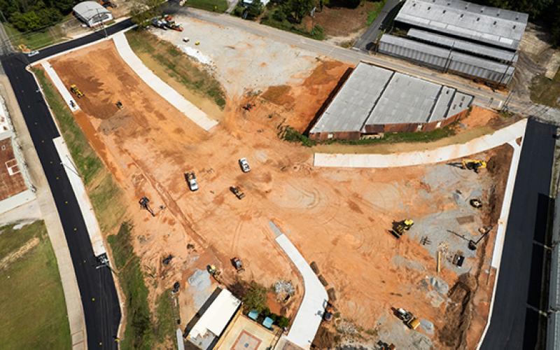 Multiple sidewalks can now be seen from above in the Anderson Park and Kinetic Amphitheater site. The brick building that backs up to the property will be the new winery for Sweet Acre Farms. (Zach Taylor/Staff)