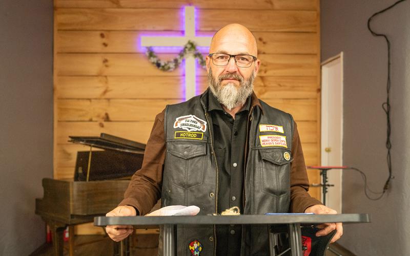 Heaven’s Saints Motorcycle Ministry Midway Chapter President Johnny Johnson stands at the altar at Clearview Baptist Church, where he serves as the pastor. (Zach Taylor/Staff)