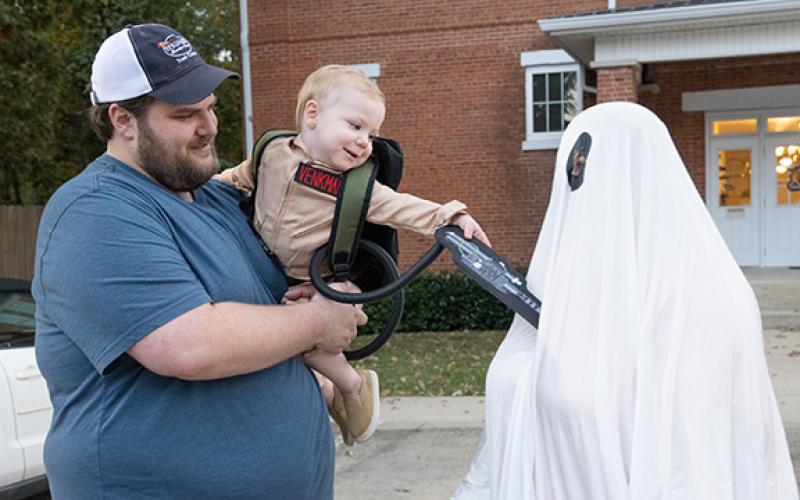 Dalton Pitts (center) worked on his ghostbusting skills with his parents, Victoria and Alex Pitts, during Mt. Airy’s Trunk or Treat event last year. (Zach Taylor/Staff)