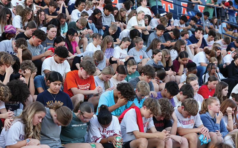 Students fill the stands while praying together during Fields of Faith at Raider Stadium on Wednesday, Oct. 8. It’s a student-led movement that encourages FCA Huddle Leaders, which are student leaders on its campuses that lead the huddles, to organize and lead this event for their peers. (Landen Todd/Staff)