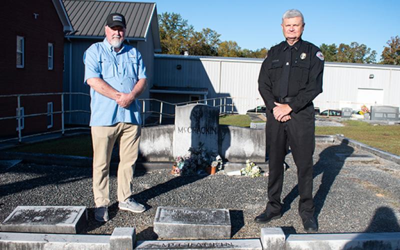 Chad White (left), a retired captain with the Hall County Sheriff’s Office and a police historian, stands with Clarkesville Police Chief Danny Clouatre at the grave of Charles Arthur Vick, a Habersham County Sheriff’s Office and Clarkesville Police Department officer who lost his life in the line of duty in 1962. (Hannah Caudell/Staff)