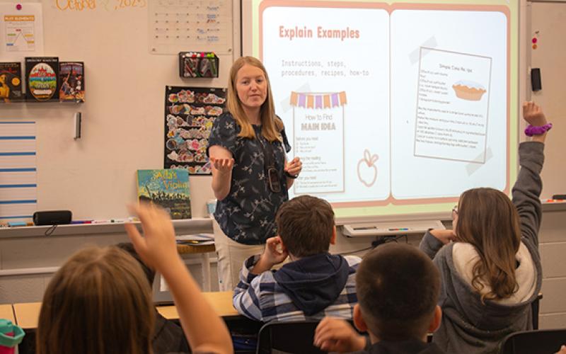 Hazel Grove Fifth Grade Teacher Stephanie Morris teaches her students about different writing genres during a class session on Tuesday morning. Morris is one of many staff members at Hazel Grove that Principal Stefanie Eaton commended on Monday night after Superintendent Patrick Franklin announced Hazel Grove had earned Title I Reward School status. (Hannah Caudell/Staff)