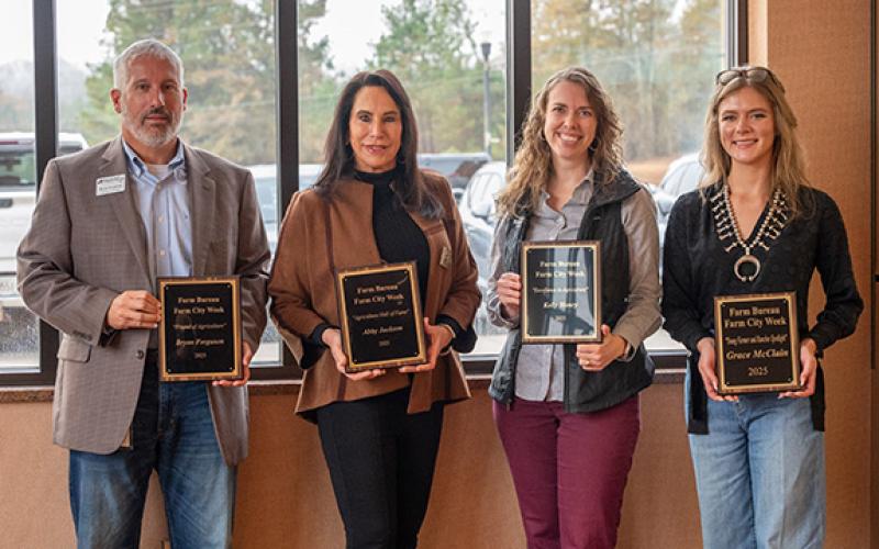 Award winners Habersham EMC President and CEO Bryan Ferguson, Blackhawk Fly Fishing CEO and Southern Farm and Garden Publisher Abby Jackson, Georgia Farm Bureau Certified Farm Market Coordinator Kelly Henry and 2025 Young Farmer and Rancher Spotlight Award Winner Grace McClain stand together for a photo after the ceremony. (Zach Taylor/Staff)