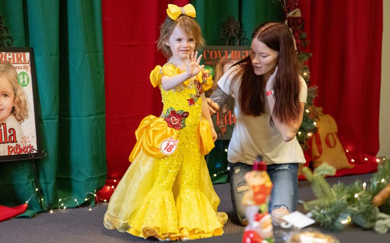 Braylin Winkles waves to the judges and the crowd during the princess dress portion of the pageant. (Zach Taylor/Staff)