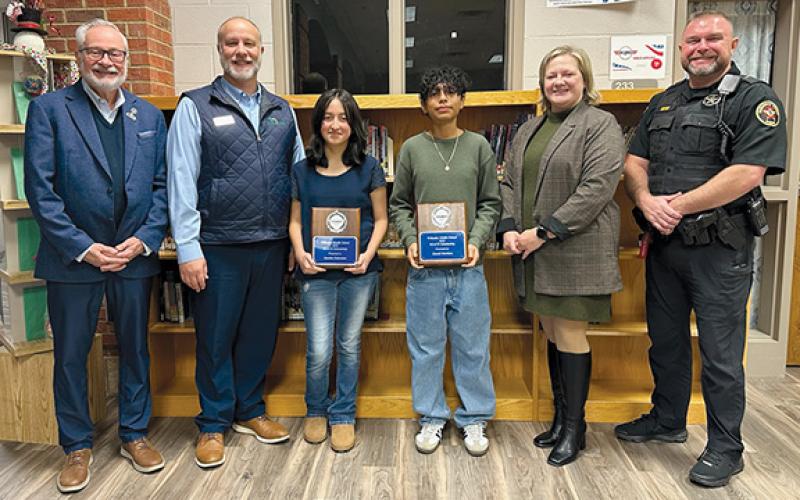 John Fair of Peachstate Federal Credit Union, Scott Roland of Peachstate Federal Credit Union, Nicole Dover of Habersham EMC and Habersham Sheriff Deputy Aaron Autry honor Wilbanks Middle School’s REACH Scholars Jasmine Solorzano and Daniel Martinez. (Submitted)