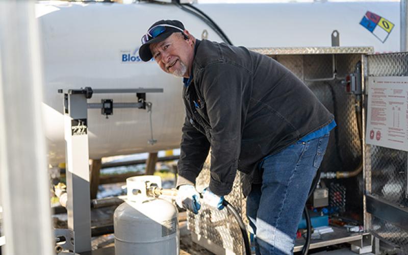 Paul Shirley, “The Propane Man,” fills up propane tanks with ease after helping distribute more than 8,000 gallons of propane at Ace Hardware in Cornelia over the past two weeks. (Zach Taylor/Staff)