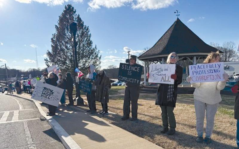 People waved signs focused on prominent issues in downtown Clarkesville Thursday. (Submitted)