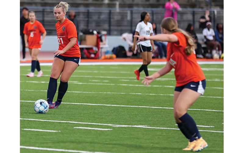 Habersham Central senior Maddox Carroll (21) passes the ball to sophomore Bailee Maney (14) during a soccer match between Alcovy and Habersham Central at Raider Stadium on March 6. (Landen Todd/Staff)