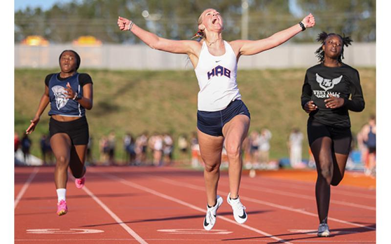 Habersham Central track and field athlete Kaylan Barrett, center, celebrates during a home meet at Raider Stadium on Tuesday, March 24. (Landen Todd/Staff)