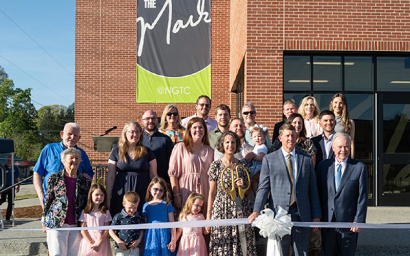 The Ivester family poses for a ribbon-cutting photo with NGTC President John Wilkinson and TCSG Commissioner Greg Dozier. (Zach Taylor/Staff)