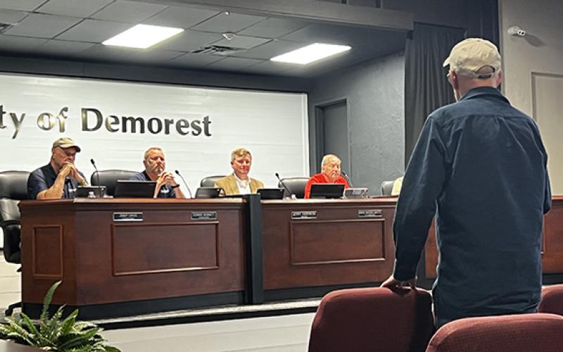 Robert Hubert speaks with Demorest Mayor Jerry Harkness opposing the proposed housing development of 34 homes on Saluda Drive. (Zach Taylor/Staff)