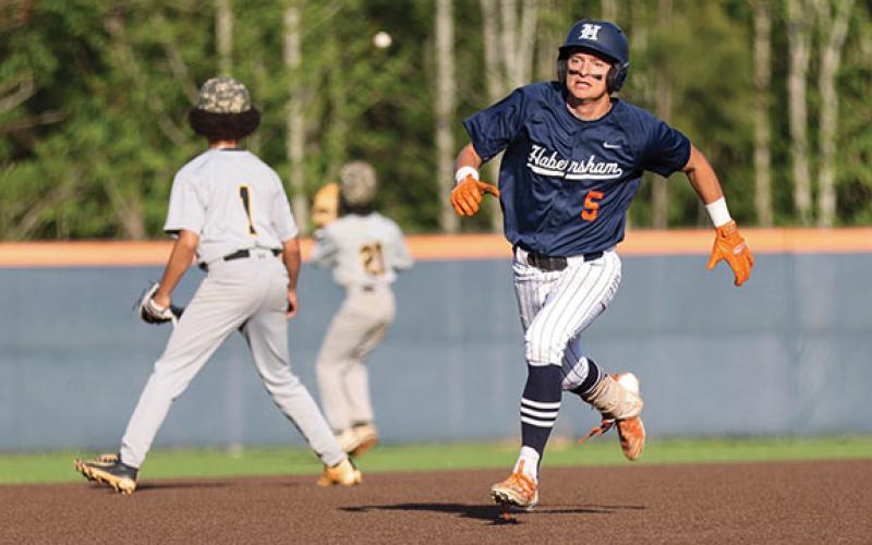 Habersham Central senior outfielder Maverick Chitwood (5) beats out the throw during a baseball game between Alcovy and Habersham Central. (Landen Todd/Staff)
