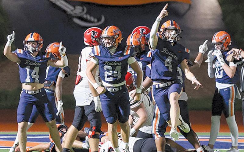 Habersham Central defenders Sawyer Burgess (14), Noah Harkins (24) and Parks York (4) celebrate a fumble during the game between Flowery Branch and Habersham Central at Raider Stadium on Friday, Aug. 22.  (Landen Todd/Staff)