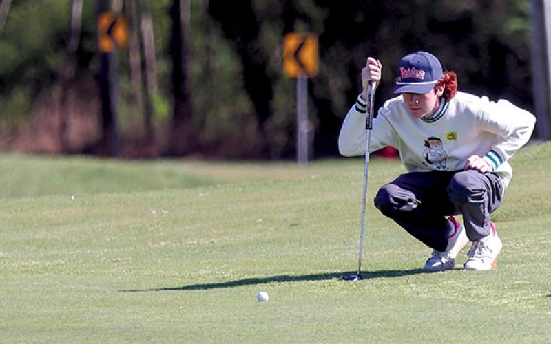 Habersham Central junior golfer Tristan Farr prepares to putt the ball. (Landen Todd/Staff)