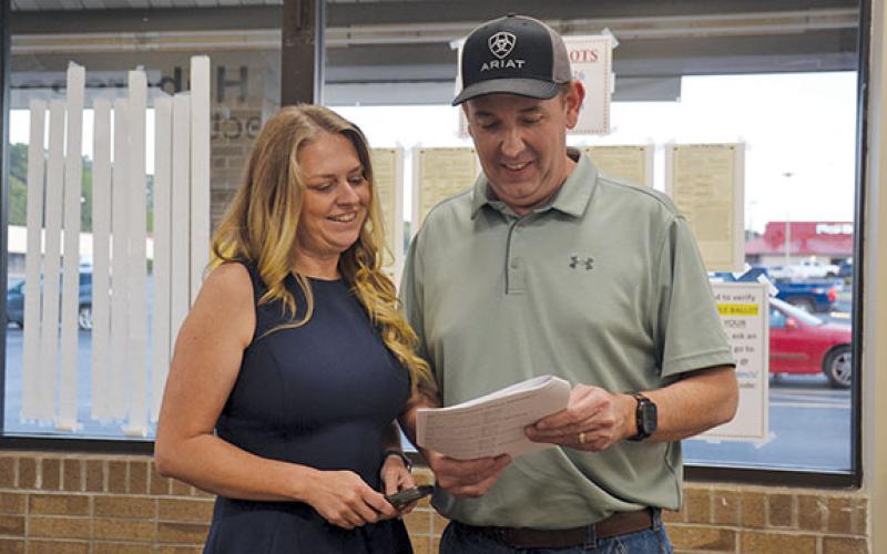 Shelley Tullis studies the absentee and early voting results with her husband, Mt. Airy Mayor Adam Tullis, as results start coming in to the Habersham County Elections and Registration Office Tuesday evening. (Samantha Sinclair/Staff)