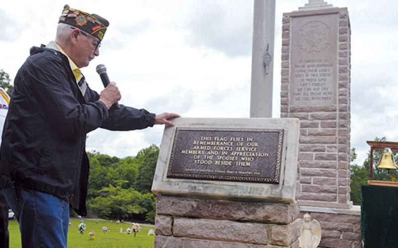 Ray Durham reads aloud the plaque during its dedication at the Memorial Day Ceremony Monday. It reads “This flag flies in remembrance of our Armed Forces service members and in appreciation of the spouses who stood beside them.” (Samantha Sinclair/Staff)