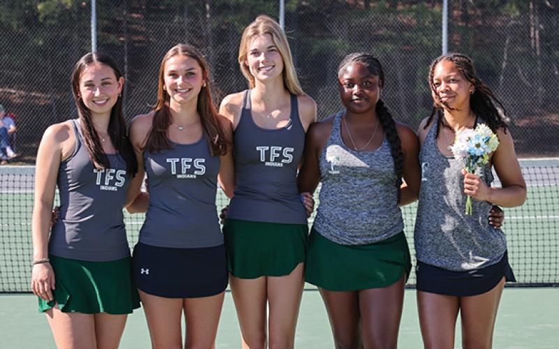 Left to right, seniors Charlotte Stafford, Keira Webb, Ava Carnes, Azaria Junaid and Jaeda-Lee Daniel-Joseph smile for a photo on the tennis court. (Submitted)