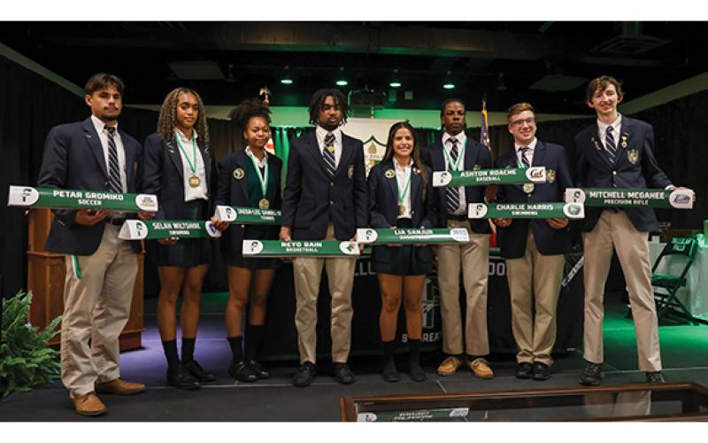 TFS student-athletes Petar Gromiko, Selah Wiltshire, Jaeda-Lee Daniel-Joseph, Neyo Bain, Lia Sanjur, Ashton Roache, Charlie Harris and Mitchell McGahee pose during the Next Level Signing Ceremony on Thursday, May 21, at the Student Activity Center. (Landen Todd/Staff)