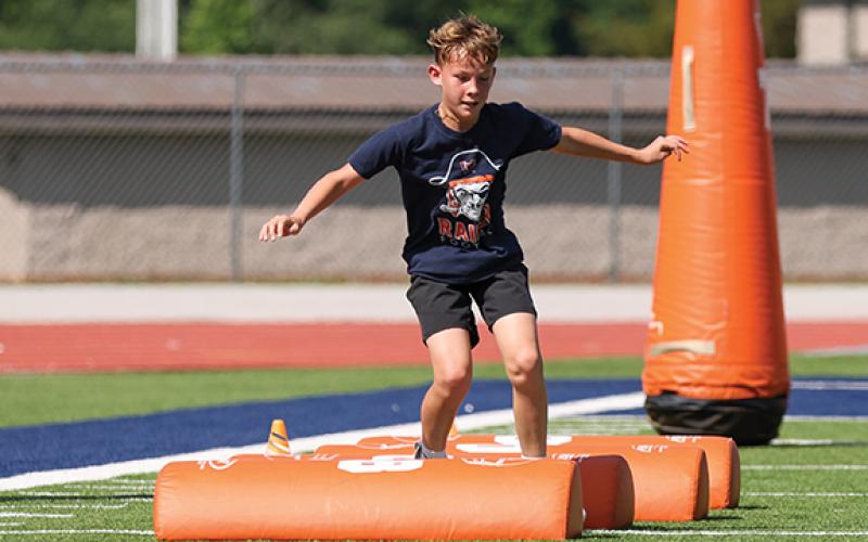 Camper Jacob Barnett shows off his skills during the HCHS football youth camp at Raider Stadium. (Landen Todd/Staff)